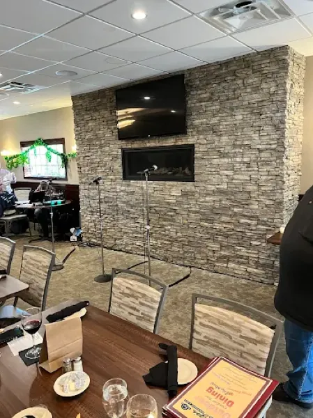 Function room with stone fireplace wall and stage setup
