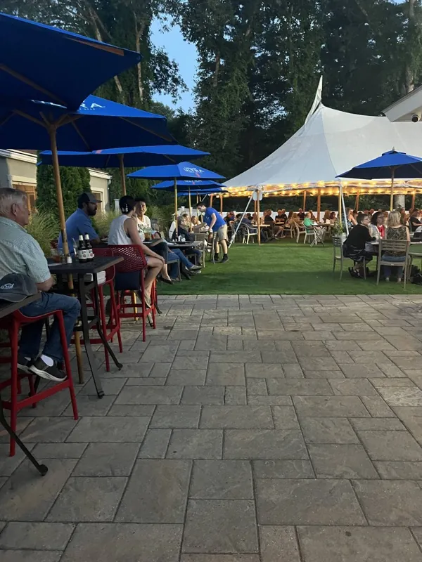 Umbrella tables and tent on the patio at dusk