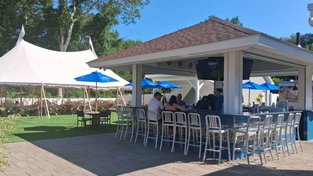 Outdoor bar pavilion with tent and umbrellas